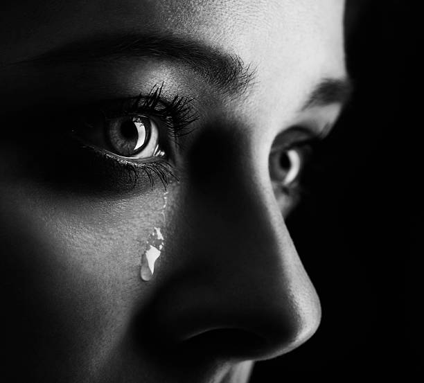 beauty-girl-cry-on-black-background-height-contrast-film-monochrom-edit